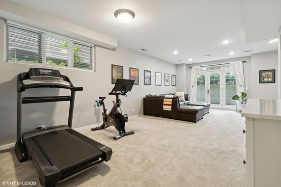 Indoor recreation area with exercise equipment and a seating area.
