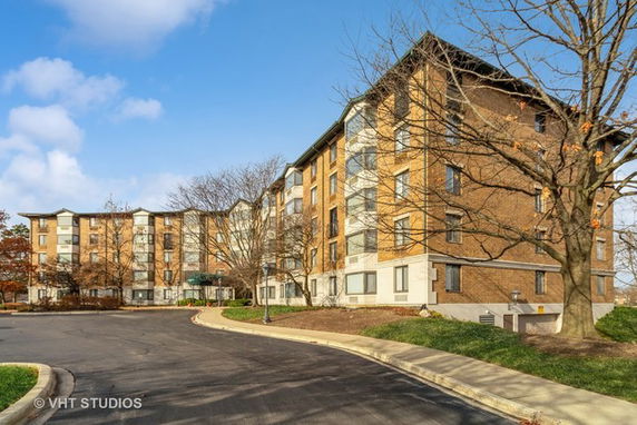 Front view of a multi-story residential building with brick facade.