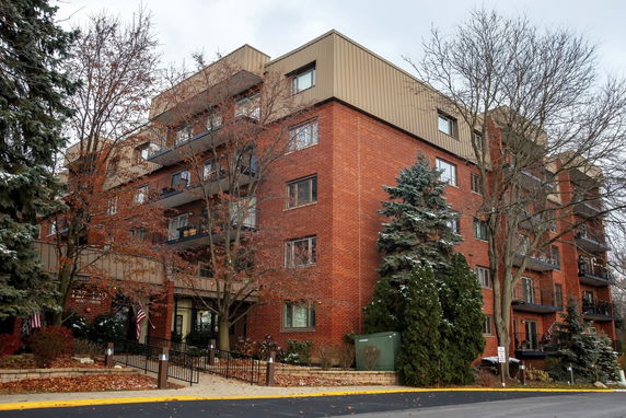 Front view of a multi-story brick building with balconies.