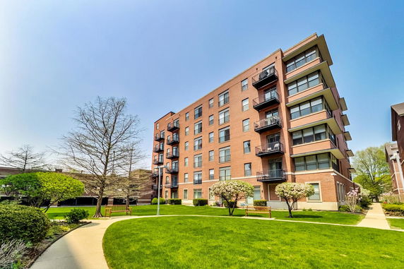 Front view of a multi-story apartment building with balconies.