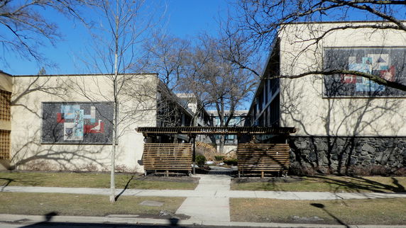 Front view of a modern building with brick and stone facade.