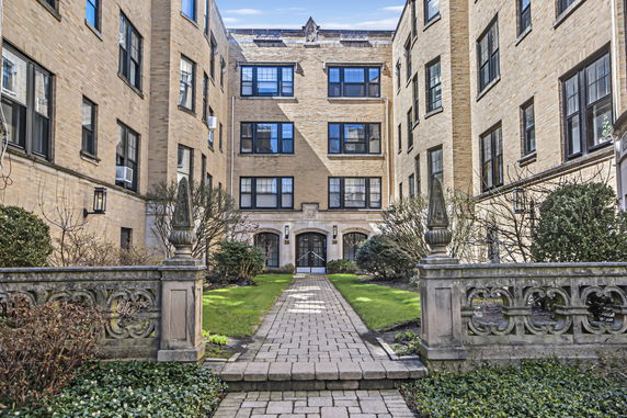 Front view of a multi-story brick apartment building.