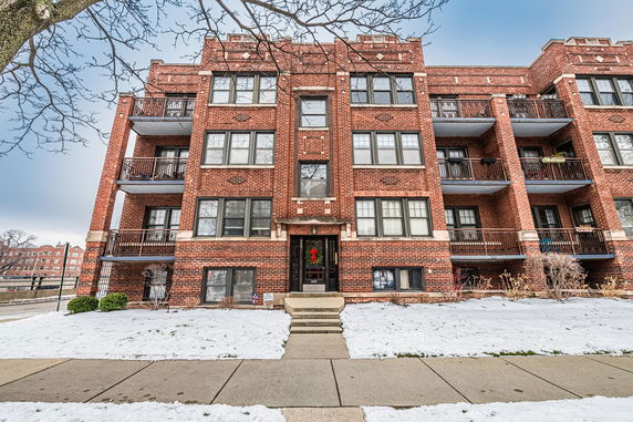 Front view of a multi-story brick apartment building.
