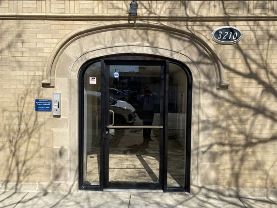 Front view of a building entrance with a glass door.