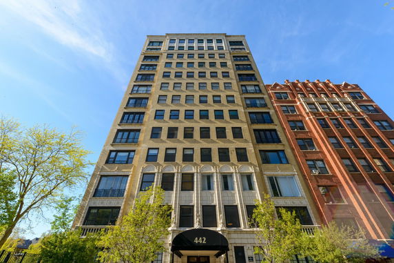 Front view of a multi-story building with a sign displaying the number 442