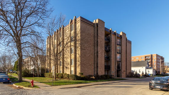Front view of a multi-story brick apartment building.