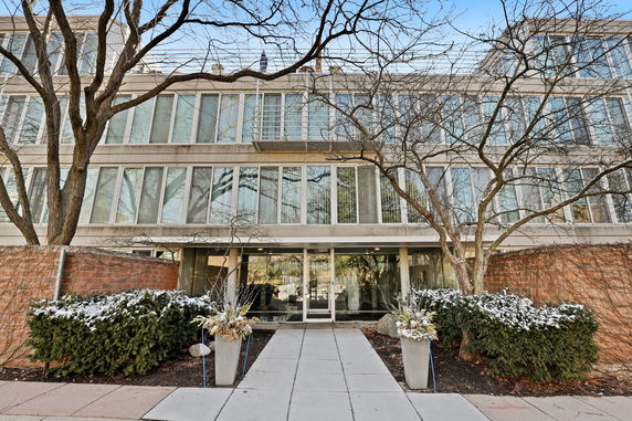 Front view of a building with large windows and a central entrance.
