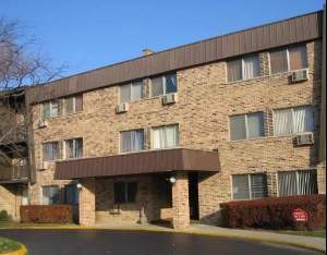 Front view of a three-story brick apartment building.