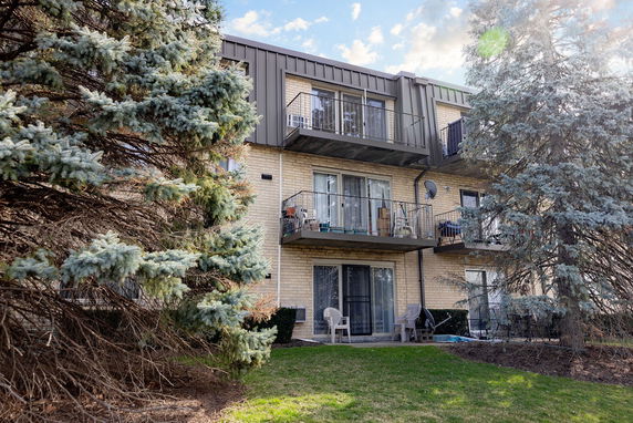 Front view of a three-story apartment building with balconies.