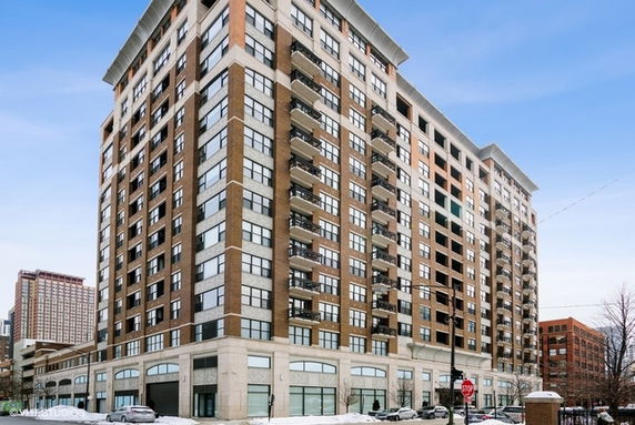 Front view of a multi-story residential building with balconies.
