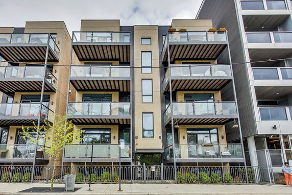 Front view of a multi-story building with balconies.