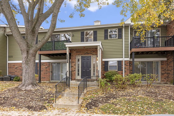 Front view of a two-story townhouse with a covered entrance.