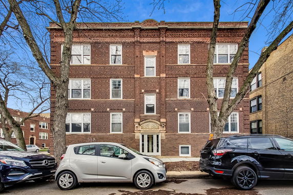 Front view of a three-story brick apartment building.