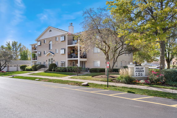 Front view of a multi-story condominium building with balconies.