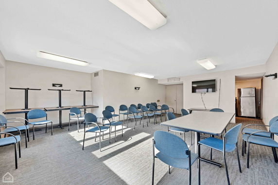 Room with chairs and tables arranged for a meeting or group activity.