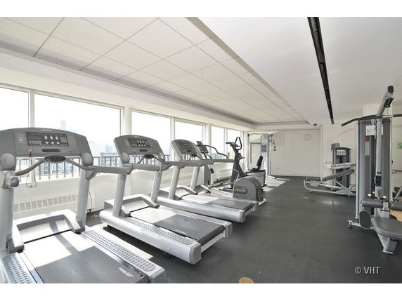 Indoor gym with several treadmills and exercise equipment.