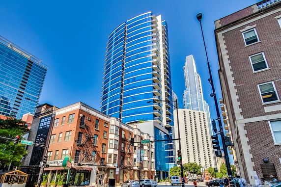 Front view of tall modern buildings with glass facades in an urban area.