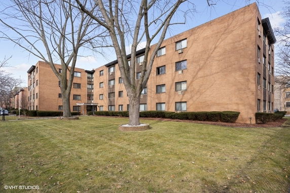 Front view of a multi-story brick apartment building.