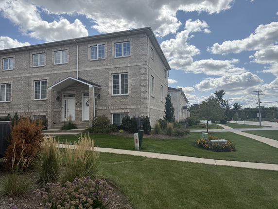 Front view of a two-story brick building with a covered entrance.