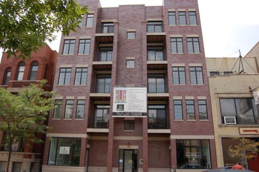 Front view of a multi-story brick apartment building