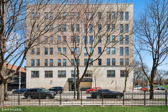 Front view of a multi-story building with numerous windows and a main entrance.