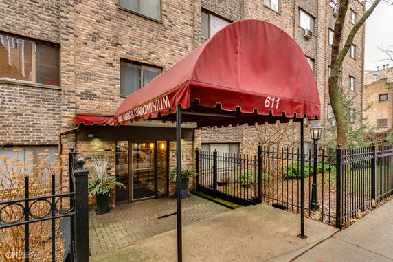 Front view of a building with a red awning entrance labeled 611.