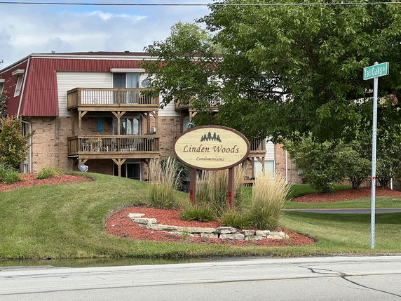 Front view of a condominium building with multiple balconies.