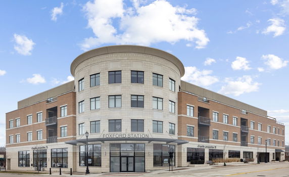 Front view of a multi-story commercial building with a rounded corner.