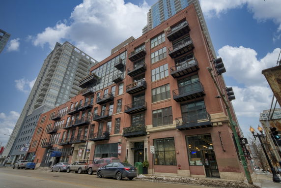 Front view of a multi-story building with balconies.