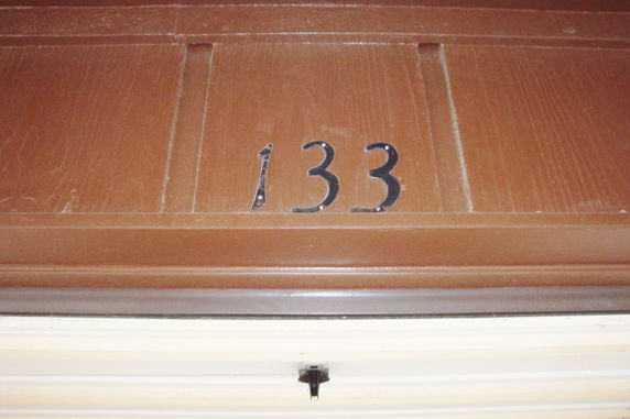 Close-up of a building entrance with the number 133 displayed.