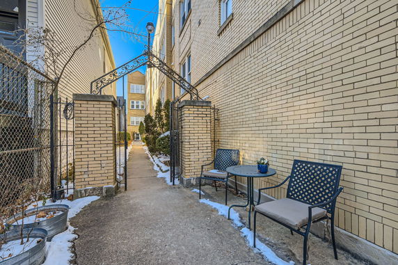 Front view of a brick apartment building with decorative entrance gate.