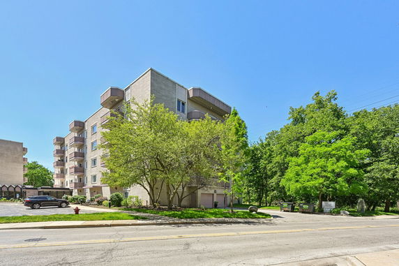 Front view of a multi-story apartment building with balconies.
