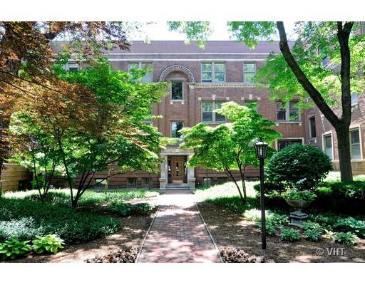 Front view of a multi-story brick building with trees and a pathway leading to the entrance.