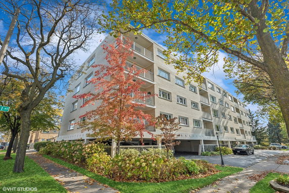 Front view of a multi-story apartment building with balconies.
