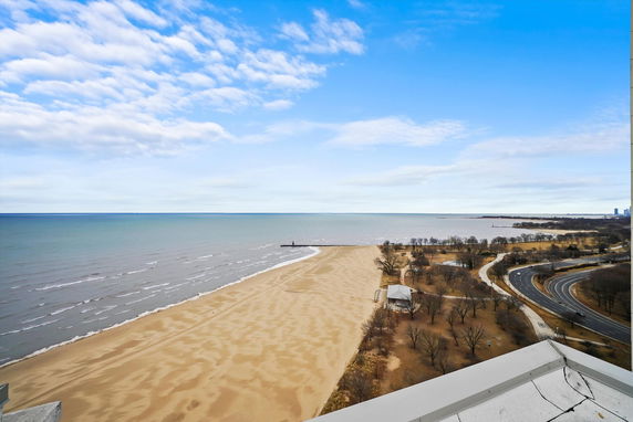 Panoramic view of a beach and coastline from a high vantage point.