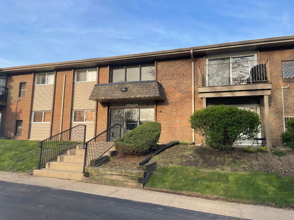 Front view of a two-story brick apartment building.