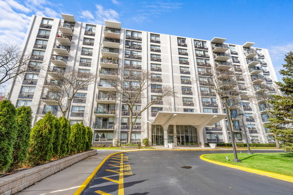 Front view of a multi-story residential building with balconies.