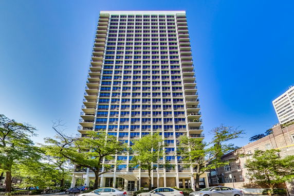Front view of a high-rise building with multiple balconies.