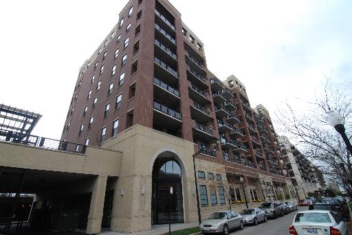 Front view of a multi-story brick building with balconies.