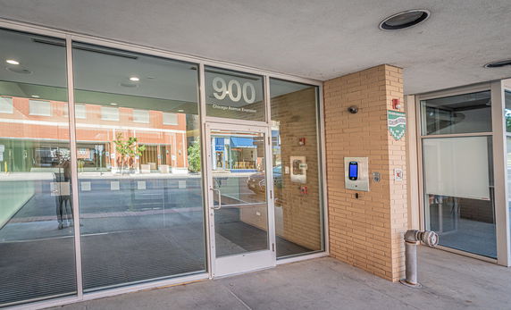 Entrance view of a commercial building with glass doors and window panels.