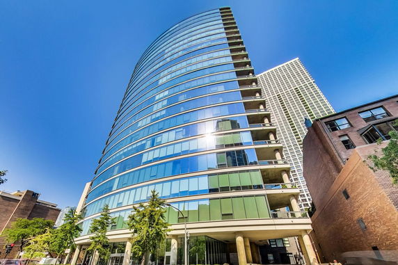 Front view of a modern multi-story building with glass facade.