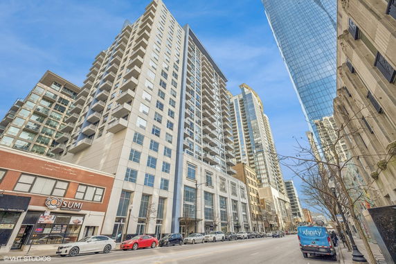 Front view of a multi-story apartment building with balconies.