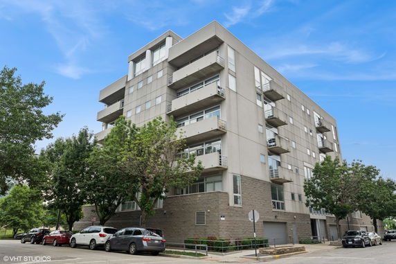 Front view of a multi-story apartment building with balconies.