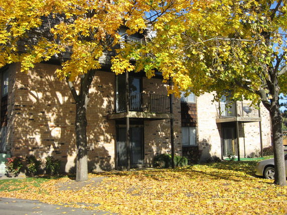 Front view of a multi-story apartment building with balconies.