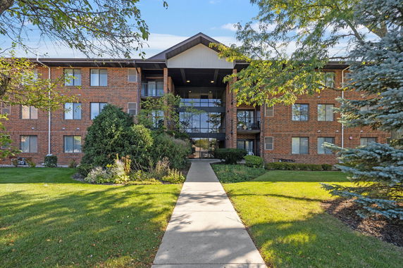 Front view of a three-story brick apartment building.