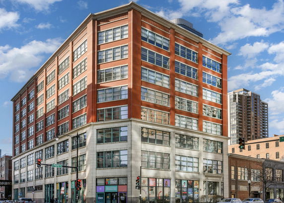 Front view of a multi-story red brick building.