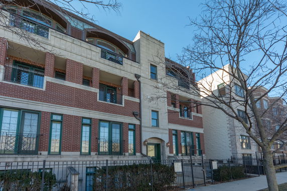 Front view of a multi-story building with brick and stone facade.