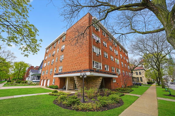 Front view of a multi-story brick apartment building.