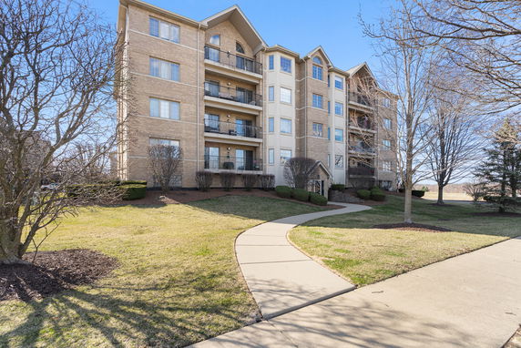 Front view of a multi-story apartment building with balconies.
