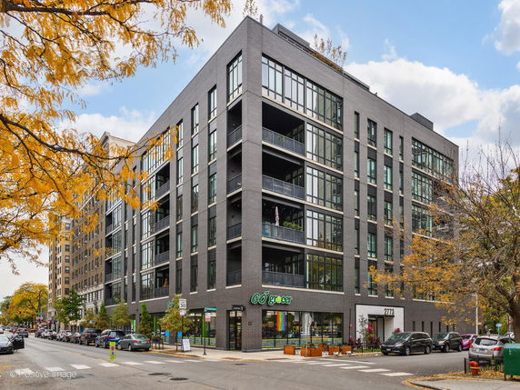 Front view of a multi-story building with large windows and a modern design.